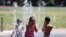 Isis Givens-Guttierrez, 9, cools off in Georgetown Playfield splash park during a heat wave in Seattle, Washington, June 26, 2021. 
