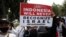 A woman holds up a poster during a rally against Israel's attacks on Gaza, outside the U.S. Embassy in Jakarta, Indonesia, May 21, 2021. 