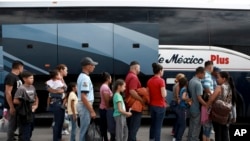 Central American migrants prepare to board a bus as they voluntarily return to their countries, in Ciudad Juarez, Mexico, July 2, 2019. 