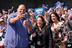 Democratic presidential nominee and U.S. Vice President Kamala Harris takes a selfie with Senator John Letterman and his wife, Gisele Barreto Fetterman, after Harris arrived in Johnstown, Pennsylvania, for a campaign event, Sept. 13, 2024.