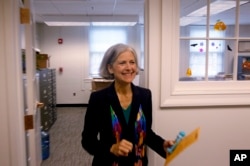 FILE - Ballot in hand, Green Party presidential candidate Jill Stein casts her ballot for U.S. president in Lexington, Mass., Oct. 26, 2012. The path for a third-party candidate contains a number of huge hurdles, the first being money.