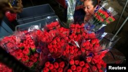 FILE - An employee organizes bouquets of flowers to be exported overseas, ahead of Valentine's Day, at Discovery Farm in Facatativa, Colombia, Feb. 8, 2018.