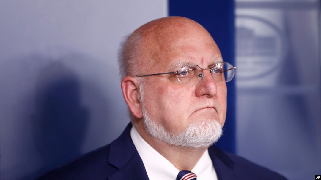 Dr. Robert Redfield, director of the Centers for Disease Control and Prevention, listens as President Donald Trump speaks during a coronavirus task force briefing at the White House, March 22, 2020, in Washington.
