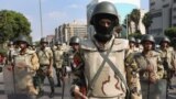 Egyptian army special forces soldiers stand guard near the Republican Guard headquarters, in Cairo. Thousands of protesters are holding rallies across Egypt to demand the reinstatement of ousted President Mohammed Morsi.