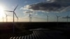 FILE - Wind turbines spin at the Klettwitz Nord solar energy park near Klettwitz, Germany, Oct. 15, 2024. 