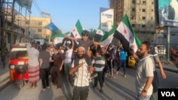 Syrian refugees in Mogadishu, Somalia, stage a demonstration Dec. 11, 2024, to celebrate the fall of Syrian President Bashar al-Assad's regime. (Seynab Abukar/VOA)