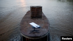 FILE - A Starlink satellite internet system is set up on a miners boat on the Madeira River in Porto Velho, Rondonia state, Brazil, July 4, 2024.