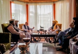 Former Afghan President Hamid Karzai (center L), senior Haqqani group leader Anas Haqqani (center R), Abdullah Abdullah (2nd R), former government negotiator with the Taliban, and others in the Taliban delegation, meet in Kabul. (Taliban Handout)