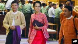 Aung San Suu Kyi, center, and other lawmakers from her National League for Democracy party leave after a regular session of parliament's lower house in Naypyitaw, Myanmar, Feb. 1, 2016. 