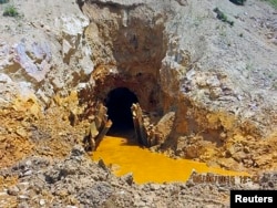 Yellow mine waste water is seen at the entrance to the Gold King Mine in San Juan County, Colorado, August 5, 2015.