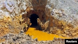 Yellow mine waste water is seen at the entrance to the Gold King Mine in San Juan County, Colorado, August 5, 2015.