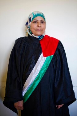 FILE - Islamic court judge Kholoud al-Faqeeh poses for a portrait during a break at the court in Ramallah, West Bank, March 29, 2016.