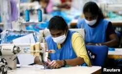 Garment workers sew skirts at a garments factory in Wattala, Sri Lanka, Nov. 2, 2017.