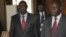 Michel Am-Nondokro Djotodia (L), leader of Central African Republic's (CAR) Seleka rebel alliance, stands beside CAR's President Francois Bozize (R) during peace talks between the government and the opposition rebels in Libreville, Gabon, January 11, 2013.