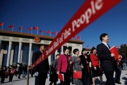 FILE - Delegates leave the Great Hall of the People after the closing session of China's National People's Congress (NPC) in Beijing, March 15, 2019.