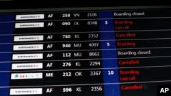 A passenger information board displays some disruptions at Roissy Charles de Gaulle Airport, in Roissy, north of Paris, Thursday, Feb.22, 2018.