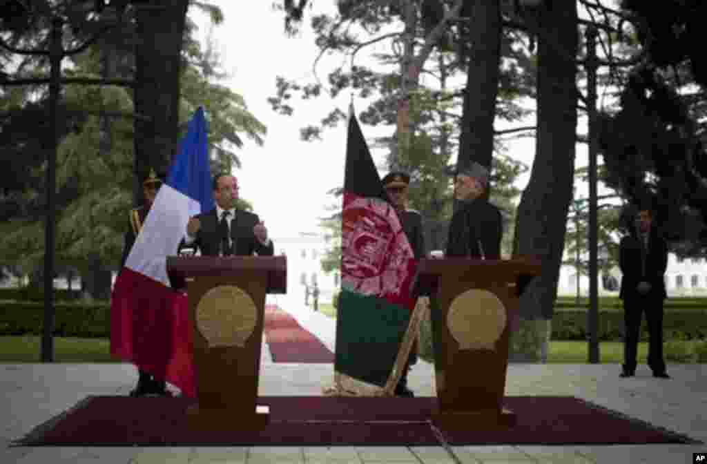 French President Francois Hollande, left, gestures during a joint press conference with Afghan President Hamid Karzai during his brief unannounced visit to Kabul, Afghanistan, Friday, May 25, 2012. Hollande announced that his country's troops had carried