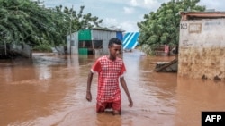 FILE - A Somali boy moves through floodwaters in Dolow on November 25, 2023.