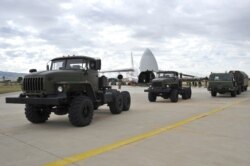 Military vehicles and equipment, parts of the S-400 air defense systems, are seen on the tarmac after they were unloaded from a Russian transport aircraft, at Murted military airport in Ankara, Turkey, July 12, 2019.