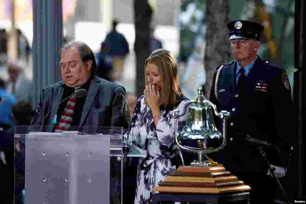 Family members read names of victims at the National 9/11 Memorial and Museum during ceremonies marking the 16th anniversary of the September 11, 2001 attacks in New York, Sept. 11, 2017.