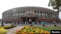 Opposition in Parliament, above, has slowed reform legislation supported by Prime Minister Narendra Modi. Although popular, Mr. Modi's party does not have a majority.