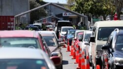 FILE - Members of the public wait in cars at a drive-through coronavirus disease (COVID-19) vaccination clinic during a single-day vaccination drive, in Auckland, New Zealand, Oct. 16, 2021.