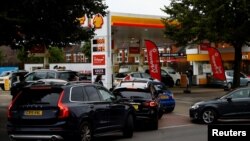Vehicles queue to refill at a fuel station in London, Sept.30, 2021.