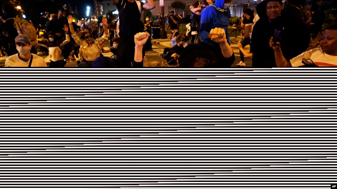 Demonstrators react as a helicopter circles low as people gather to protest the death of George Floyd, June 1, 2020, near the White House in Washington.
