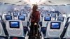 FILE - Passengers check in for a flight at Dulles International Airport in Virginia, outside Washington, D.C., July 16, 2020. (Aishwarya Airy/VOA)