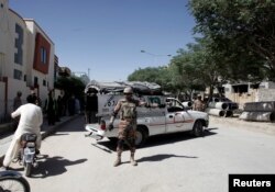 FILE - A soldier stands guard near the site where two Chinese language teachers were kidnapped by unidentified gunmen, in Quetta, Pakistan, May 24, 2017.