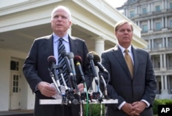 FILE - Senators John McCain, left, and Lindsey Graham, following a closed-door meeting with President Barack Obama to discuss the situation with Syria, Sept. 2, 2013.
