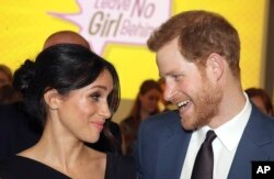 FILE - Britain's Prince Harry, left and Meghan Markle attend a women's empowerment reception at the Royal Aeronautical Society, during the Commonwealth Heads of Government Meeting, in London, April 19, 2018.