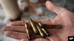 An Afghan man displays some of the used bullets at the scene where Sabar Lal Melma, a former Guantanamo detainee was allegedly killed in a NATO and Afghan forces raid in Jalalabad, Nangarhar province, east of Kabul, Afghanistan, September 3, 2011.