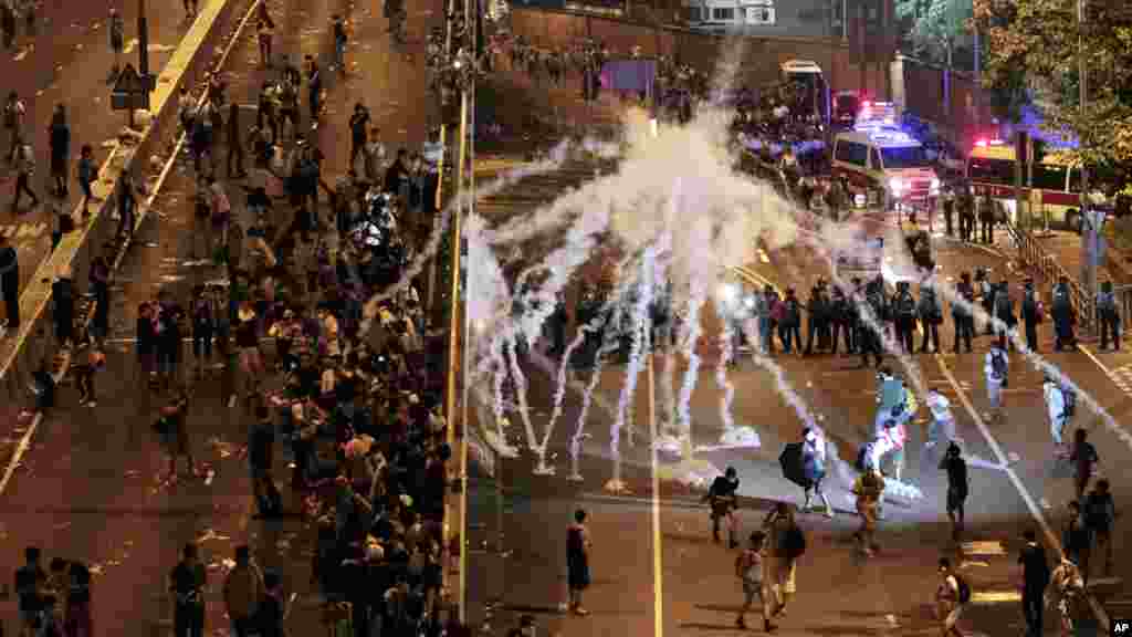 Riot police fire tear gas on student protesters occupying streets surrounding the government headquarters in Hong Kong, early Sept. 29, 2014. 