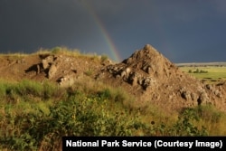A rainbow forms after a storm at Badlands National Park