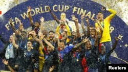 FILE - Hugo Lloris lifts the trophy as France celebrates after winning the World Cup July 15, 2018. (REUTERS/Kai Pfaffenbach)
