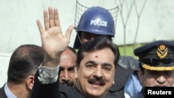 Pakistan's former Prime Minister Yusuf Raza Gilani waves after arriving at the Supreme Court in Islamabad, April 26, 2012.