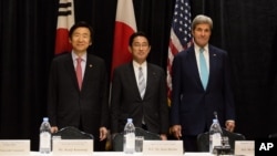 Minister of Foreign Affairs Yun Byung-se of South Korea, left, Minister of Foreign Affairs Fumio Kishida of Japan, and U.S. Secretary of State John Kerry stand for a photo during a meeting between the three leaders Sunday, Sept. 18, 2016, in New York . 