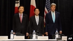 Minister of Foreign Affairs Yun Byung-se of South Korea, left, Minister of Foreign Affairs Fumio Kishida of Japan, and U.S. Secretary of State John Kerry stand for a photo during a meeting between the three leaders Sunday, Sept. 18, 2016, in New York .