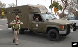 A sheriff's hostage negotiation team passes a California highway patrol checkpoint at the Veterans Home of California in Yountville, California, March 9, 2018.