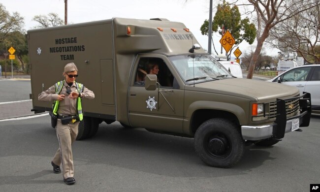 A sheriff's hostage negotiation team passes a California highway patrol checkpoint at the Veterans Home of California in Yountville, California, March 9, 2018.