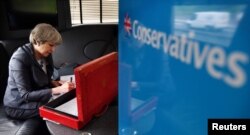 Britain's Prime Minister Theresa May works on her campaign bus as it travels through Staffordshire, June 6, 2017.