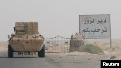 A road sign welcomes people to the town of Deir el-Zour in Syria, Sept. 20, 2017.