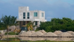 A bulldozer clears a field next to mangroves lining a shoreline near Dzilam de Bravo, in Mexico’s Yucatan Peninsula, Oct. 7, 2021. Cutting mangroves has been a crime since 2005. The Yucatan state government said it is aware of complaints of illegal loggin