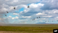 Photo provided by Russian Defense Ministry Press Service on Sept. 11, 2018 shows Russian military helicopters flying in the Chita region, Eastern Siberia, during the Vostok 2018 exercises in Russia.