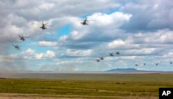 Photo provided by Russian Defense Ministry Press Service on Sept. 11, 2018 shows Russian military helicopters flying in the Chita region, Eastern Siberia, during the Vostok 2018 exercises in Russia.