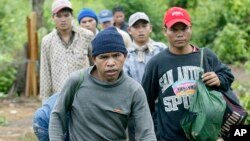 Montagnards emerge from the forest after having fled from neighbouring Vietnam in Korng village, Ratanakiri province, northeastern Cambodia, 10 kilometers (6.3 miles) from the Vietnamese border, in this Thursday, July 22, 2004 file photo. Twenty-seven Vie