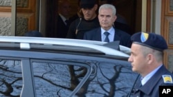 Zivko Budimir, a president of the Bosniak-Croat Federation, is escorted by police during his arrest, in the Bosnian capital of Sarajevo, April 26, 2013. 