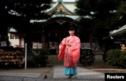 Shinto priest Tomoe Ichino, 40, poses for a photograph at the Imado Shrine in Tokyo, Japan, Feb. 22, 2017.