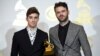 Andrew Taggart, left, and Alex Pall of The Chainsmokers pose in the press room with the award for best dance recording for "Don't Let Me Down" at the 59th annual Grammy Awards at the Staples Center on Feb. 12, 2017, in Los Angeles. 